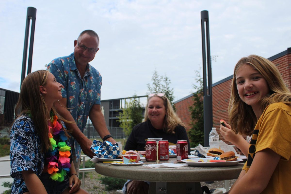 Families pose for a picture at Rachel Stone's Fundraiser. BBQ and drinks are served. Picture taken August 30, 2024.