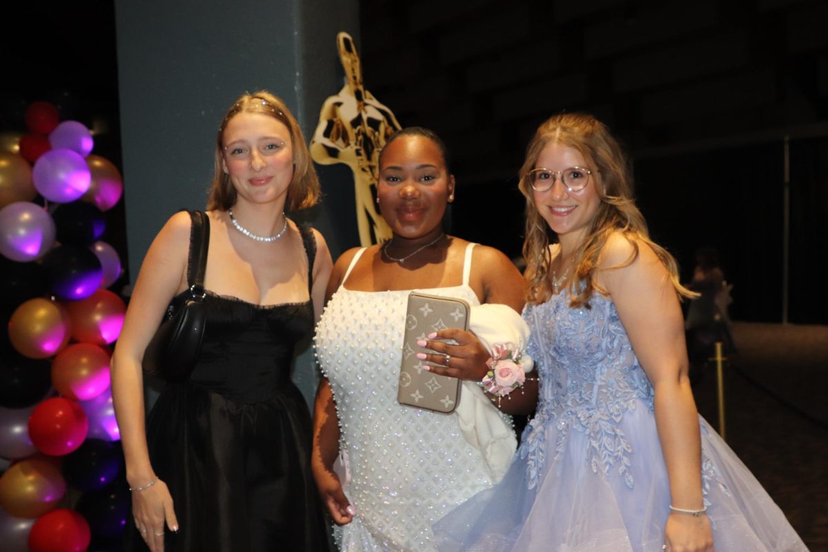 Perfect prom moment. Seniors Naomi Butler, Aurora Hilbert, and Noellie Pot pose for a picture as they are having a blast at prom. Aurora and Noellie are foreign exchange students. 
“It was me and my friends having a good time. We definitely had a really fun night we were taking a lot of pictures.”