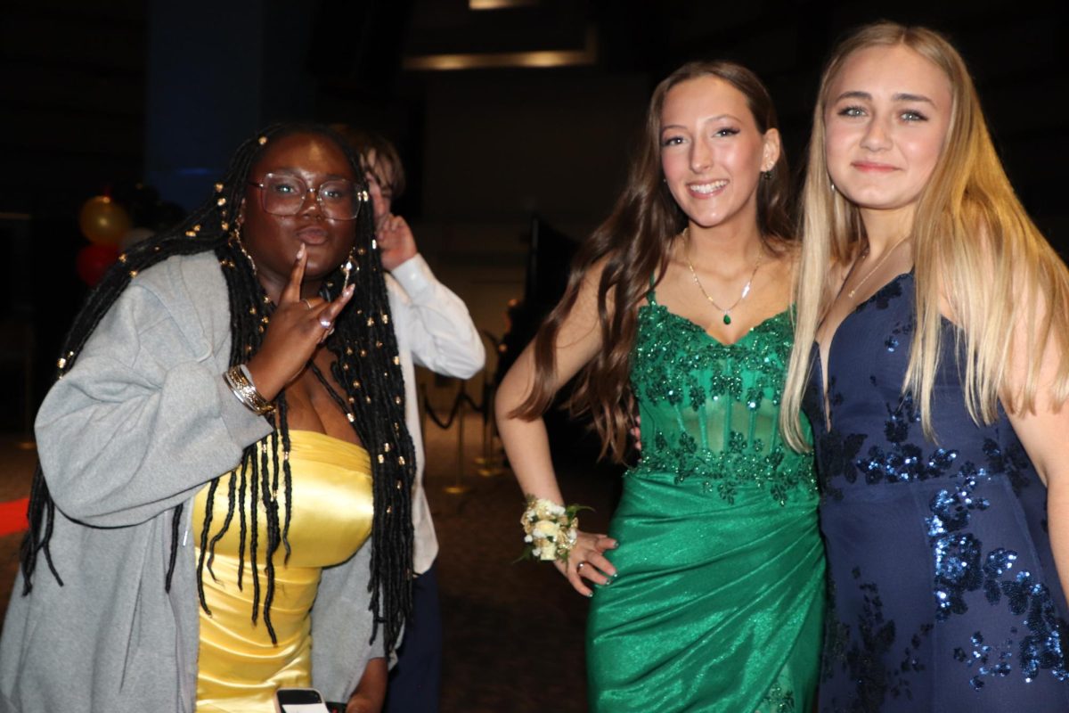 Making Prom Fun. Senior Mydia Childs, Sophomore Georgia Graves, and Junior Sophie Booth pose for a picture together after greeting each other. “Prom is super fun, you just gotta dance and have fun with your friends,” Booth said.
