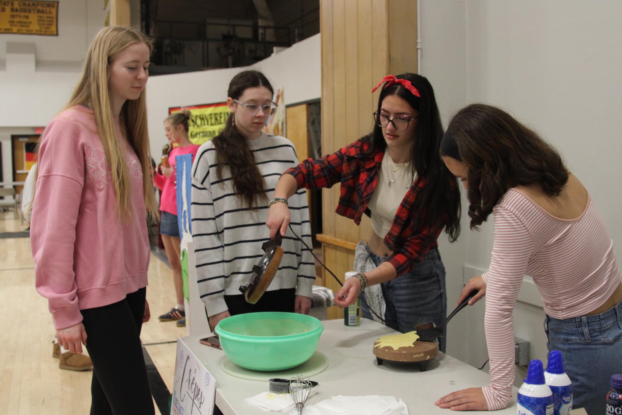Flip It: National French Honor Society students bake crêpes for their booth at the annual cultural festival.  
