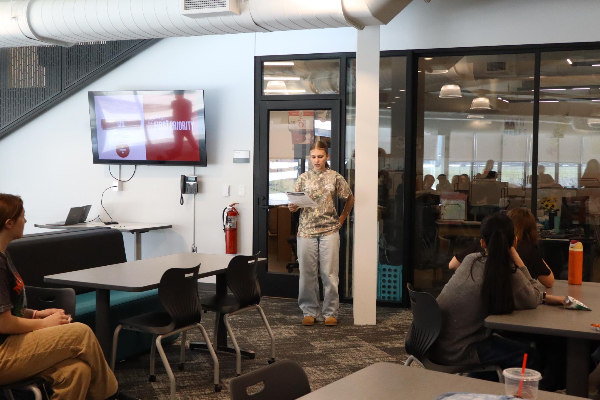 Student stands before fellow peers during the First Priority meeting last Thursday. 