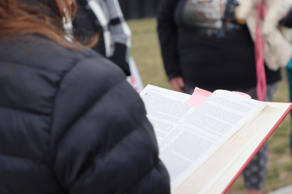 Sierra reads from her Bible during the event. Photo by Leif Wilson. 

