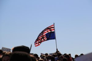 Flying flags against ICE. Approximately 300 students marched out of school for the ‘ICE Walkout’. “So many people are showing up for such an important cause and more people need to stand with us and say, melt ice. No more ice,” a student named Elizabeth said. Photo by Addison Williams.
