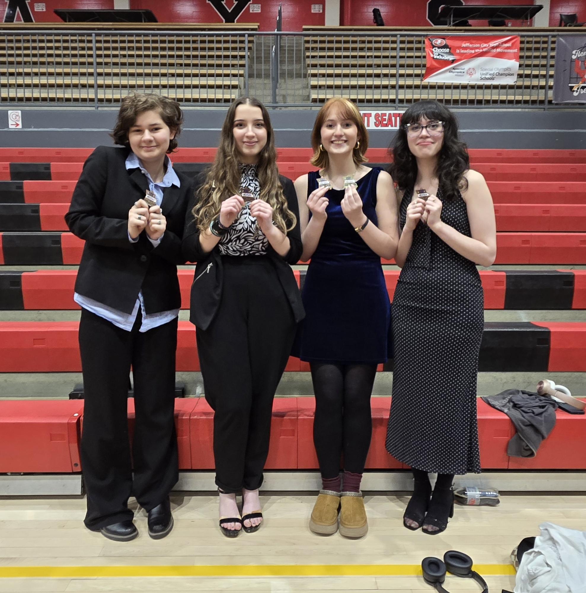 Phoenix, Evie, Madi, and Raina posed at the debate tournament. Photo by Nate Smith.
